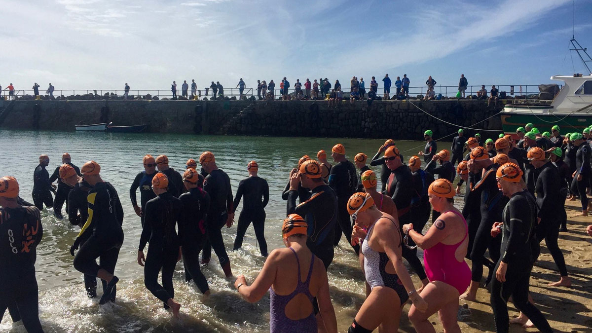 Swimmers walking down the beach for a sea swimming race.