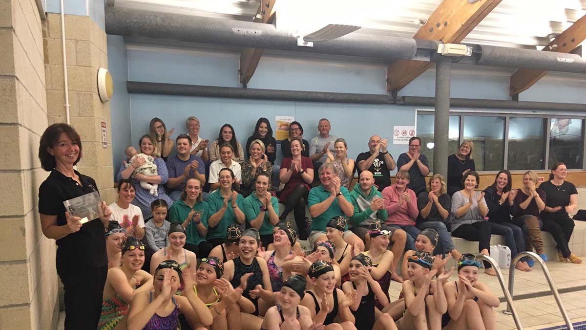 Clair Murphy, far left, with her award and members and parents from Calne Alpha Synchronised Swimming Club