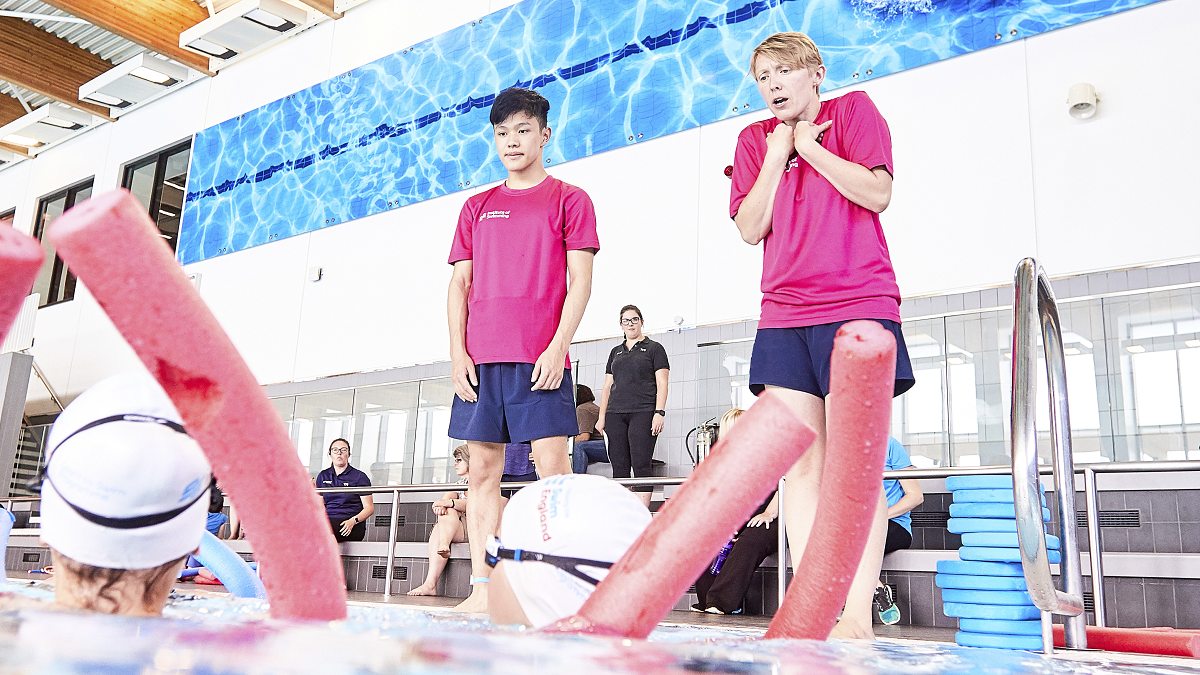 Swimming teachers on poolside